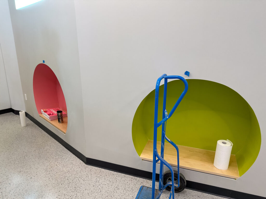 wall with rounded cubbies painted bright colors