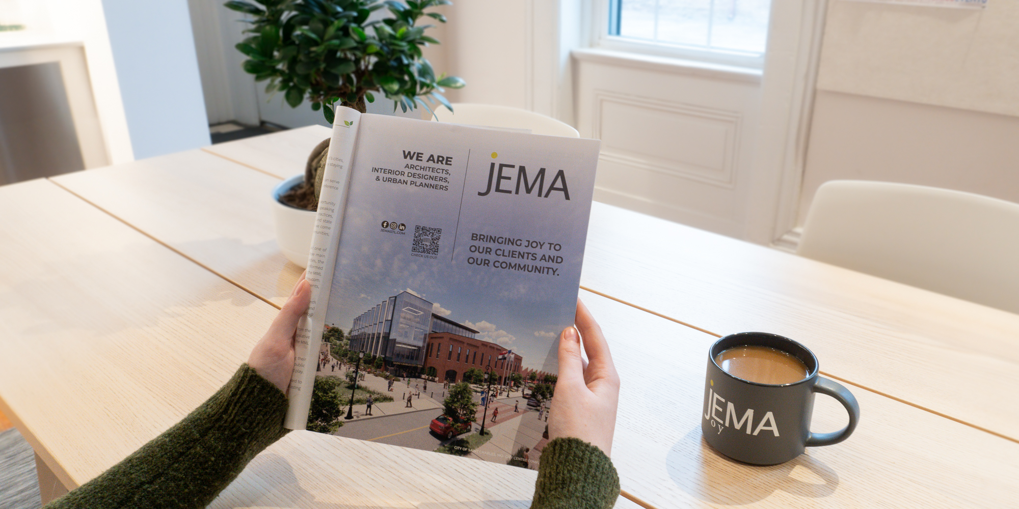 image of person holding a magazine with whole page JEMA ad printed