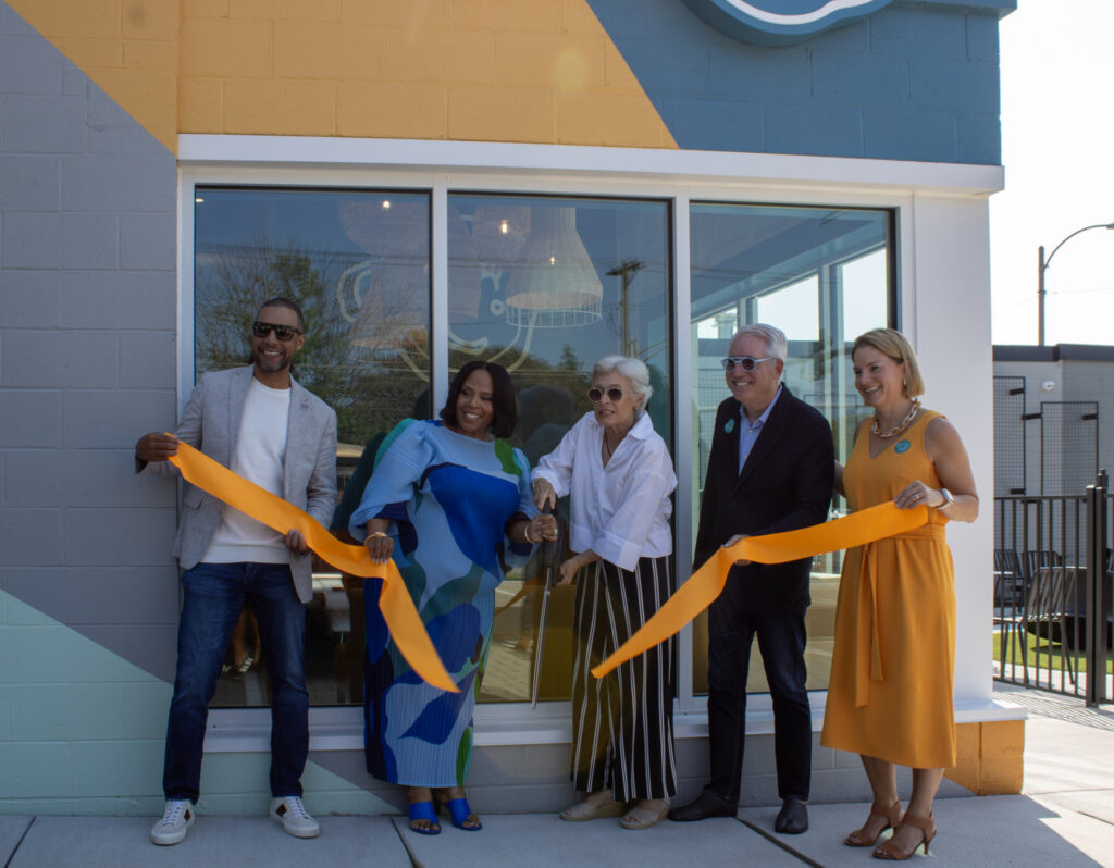 Urban Sprouts donors cutting the ribbon in front of their new Cafe Au Play