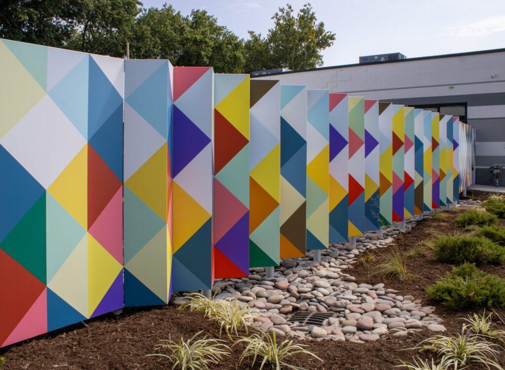 Urban Sprouts new bright colored geometric fence enclosing their new playground